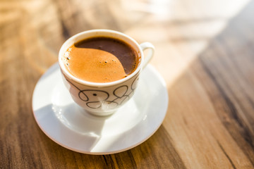 Turkish coffee on a wooden cafe table