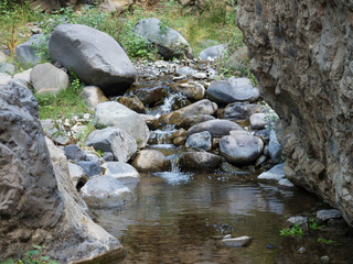 Small water stream at ravine of the Barranco de las Angustias canyon at hiking trail Caldera de Taburiente, La Palma, Canary Islands, Spain.
