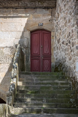 View at a medieval entrance door with a staircase, on a traditional urban building house on Viseu city Downtown