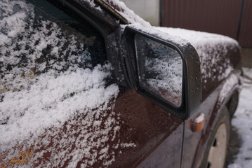 car mirror covered with snow
