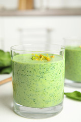 Green buckwheat smoothie on white table, closeup