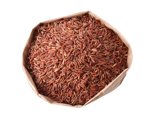 Brown rice in paper bag isolated on white, top view