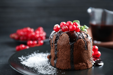 Fototapeta na wymiar Delicious warm chocolate lava cake with mint and berries on plate, closeup. Space for text