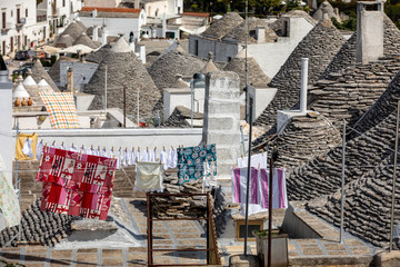 Laundry drying over the stone roofs of a Trulli houses in Alberobello, Puglia, Italy