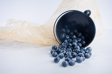 blueberries in a bowl on wooden table