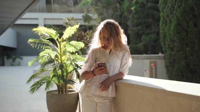 Preteen girl using her modern smartphone in hands