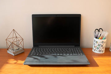 Fototapeta premium Grey laptop on office desk