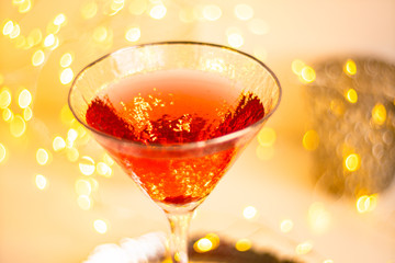 Classic red cocktail in fancy texture glass on bright light bokeh background
