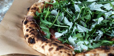 Home made italian style pizza on wooden rustic table