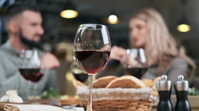 Close up glass wine on table during dinner of young couple at restaurant. Shot with RED camera in 4K