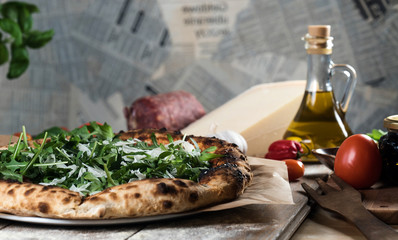 Home made italian style pizza on wooden rustic table
