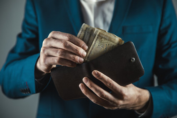 business man hand money with wallet