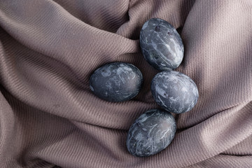 Background with easter eggs. Naturally dyed eggs prepared for Easter on gray texture tablecloth background. Happy Easter
