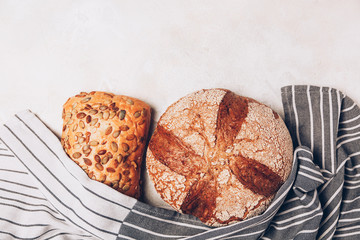 Different kinds of bread on white backdround. Top view, flat lay.