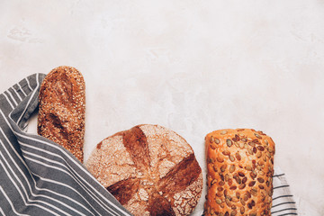 Different kinds of bread on white backdround. Top view, flat lay.