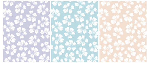 Simple Hand Drawn Floral Vector Patterns. Pastel Color Floral Repeatable Design.White Delicate Flowers Isolated on a Blue,Violet and Yellow Background.Garden Print for Fabric, Textile, Wrapping Paper. © Magdalena