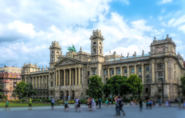 Fototapeta na wymiar Budapest / Hungary - August 29 2019: Facade of the historic luxury building of the Ethnographic Museum in Budapest, Hungary. Ancient building with columns against the blue sky and green city park