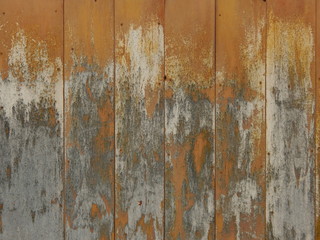 old wooden surface from textured boards with traces of paint and environmental influences