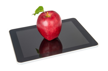 Back to school apple with leaf sitting on digital tablet computer on white background