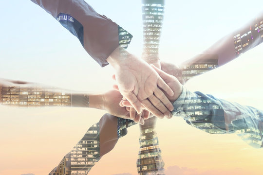 Happy image of businesspeople Teamwork Concept,Group of diversity people putting their hands together ,hand a young business people join hands partnership teamwork concept