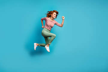 Fototapeta na wymiar Full length profile photo of beautiful lady jump high active rushing final season shopping center wear casual red white shirt green trousers footwear isolated blue color background