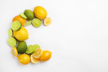 Letter C made with citrus fruits on white background as vitamin representation, top view