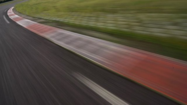 POV driving full speed towards curb on a race track