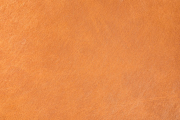 Texture of orange leather as background, closeup