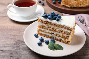 Tasty cake with berries on wooden table