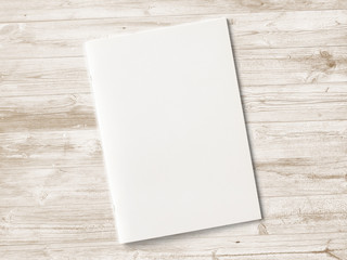 Blank Magazine with soft shadows on wooden desk as template for designers presentation, showcase etc.
