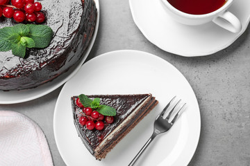 Tasty chocolate cake with berries on grey table, flat lay