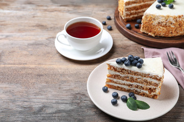 Tasty cake with berries on wooden table