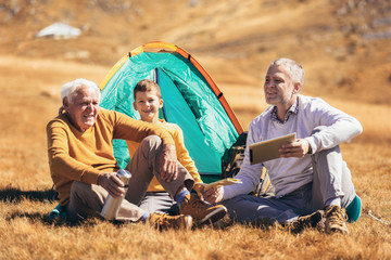 Three generations of family camping together in the autumn.