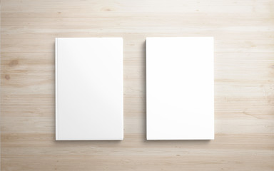 2 Book with white hardcover on wooden desk. 