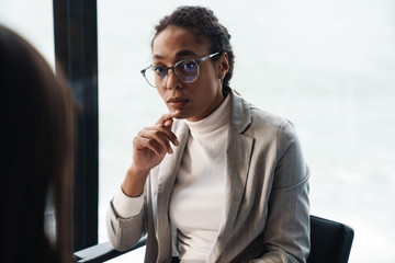 Portrait of young brunette businesswomen during job interview in office