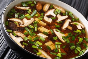 Dietary soup with shiitake mushrooms, tofu and green onions close-up in a bowl. horizontal