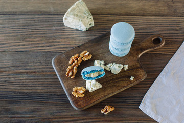 Cheese and walnuts with dessert on a blackboard