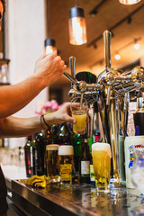 bartender pouring beer in a bar