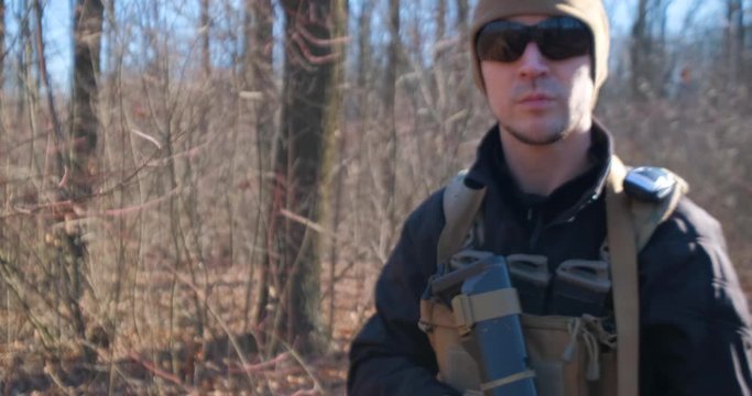 Male from private military company with rifle in the forest	