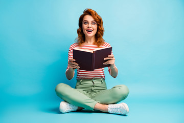 Full size photo of excited crazy woman nerd sit floor legs crossed read book impressed by story...