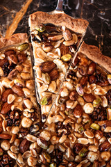 Slice of nut cake, five kinds of nuts, vegetarian dessert. Macro shooting.