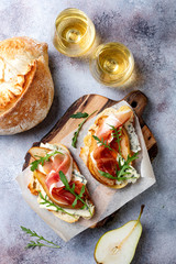 Appetizer crostini, tapas, open faced sandwiches with pear, prosciutto, arugula and blue cheese....