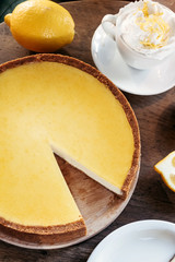 Lemon cheesecake, shop cafe, still life with coffee. Business background.