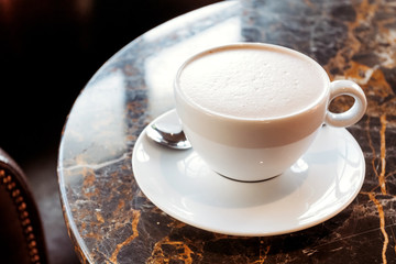 Cup of cocoa in cafe on table. Hot drinks background.