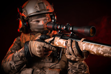 special forces soldier in a helmet with a sniper rifle