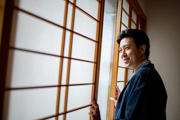 Lovely Asian man wearing Yukata japanese tradditional cloth in traddition Japan style  in Tatami...