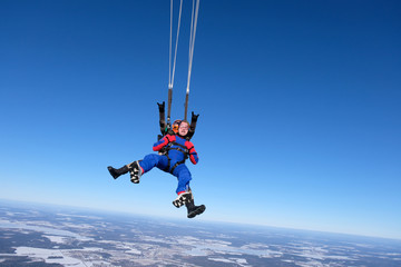 Skydiving. Tandem jump. Two men are having fun in the sky.