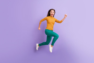 Fototapeta na wymiar Full length body size view of nice attractive lovely cheerful cheery glad excited energetic girl jumping running fast movement isolated on violet purple lilac pastel color background
