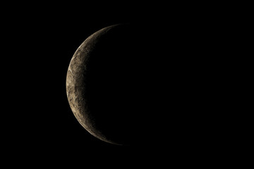 A little planet with light from the sun shining just a little from behind the left side in the dark. 3D rendering