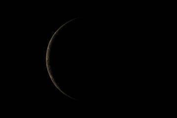 A little planet with light from the sun shining just a little from behind the left side in the dark. 3D rendering